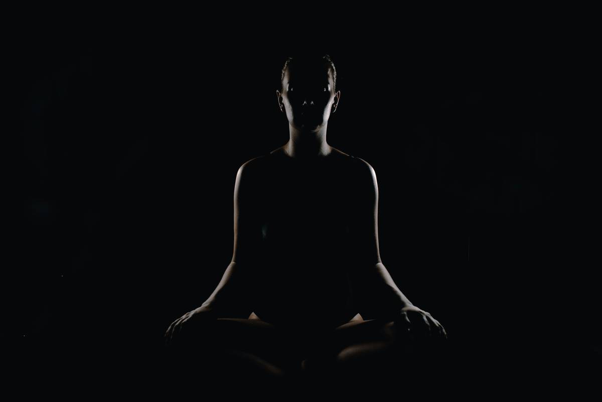 Woman practicing relaxed inhale while seated calmly with eyes closed