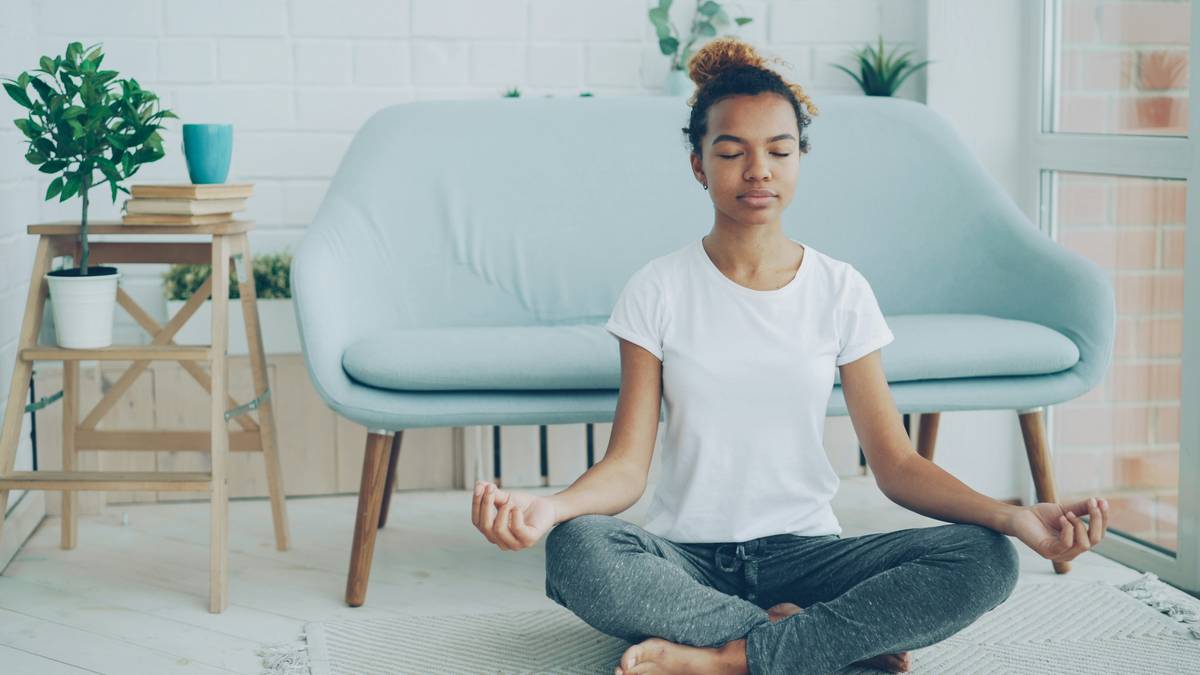 Woman practicing breath pacing technique while seated calmly with eyes closed